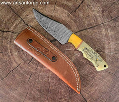 Hand-forged Damascus steel hunting knife with white camel bone handle, bear engraving, and leather sheath.