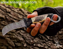 Damascus steel hawkbill knife with stag handle.