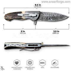 Close-up of hand-forged Damascus folding blade with intricate raindrop pattern and sharp cutting edge.