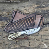 Cowboy knife and sheath with stag antler handle and leather pancake sheath.