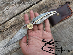 Handmade Damascus Pocket Knife displaying intricate twist pattern blade and Damascus steel handle.