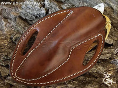 Cross Draw Cowboy Knife securely fastened in a custom-made, hand-stitched leather sheath.