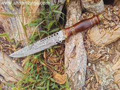 Ergonomic rosewood handle of the custom Damascus hunting knife with a brass finger guard and pommel, highlighting its craftsmanship.
