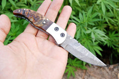 Close-up of twist pattern Damascus folding blade.