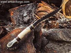 Damascus Steel Best kukri knife with a twist pattern on display. This hand-forged kukri features a brass guard, camel bone and stag antler handle, and a genuine leather sheath.