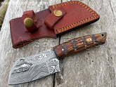 Damascus Bushcraft Knife with raindrop pattern, fixed blade, Pakkawood handle, and leather sheath.