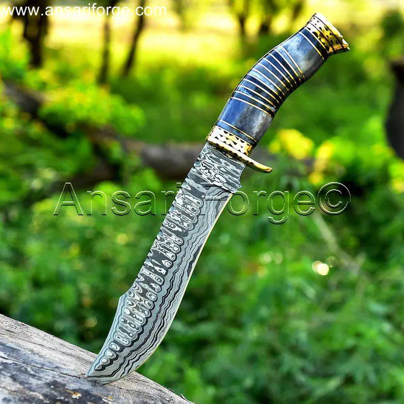 Damascus Bowie Hunting Knife with intricate ladder pattern, brass hilt, and bone handle.