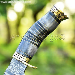Bone handle of a Damascus Bowie Hunting Knife with detailed carvings.