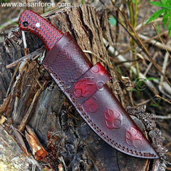 Damascus hunting knife in a handmade leather sheath, horizontal carry.