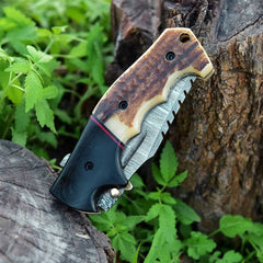 Compact Damascus Pocket Knife Closed with Visible Antler Handle Scales.