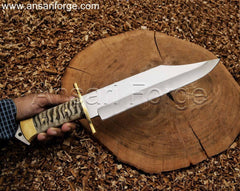 Custom handmade Bowie knife with 5160 steel clip point blade, ram horn handle, and leather sheath.