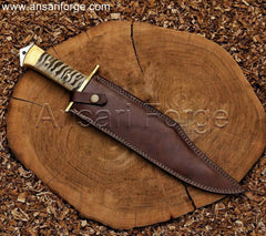 Custom handmade Bowie knife with 5160 steel clip point blade, ram horn handle, and leather sheath.