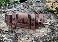 Hammered 1095 steel knife secured in leather sheath.