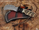 Hand-forged Hawkbill knife with Damascus steel blade, leather sheath and sheep horn handle.