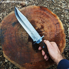 Red Dead Redemption 2 Bowie Knife being used to chop firewood on a campsite, sparks flying from the blade.