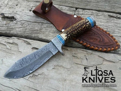 Custom Hunting Knife with a hand-forged Damascus steel blade and hand tolled leather sheath.
