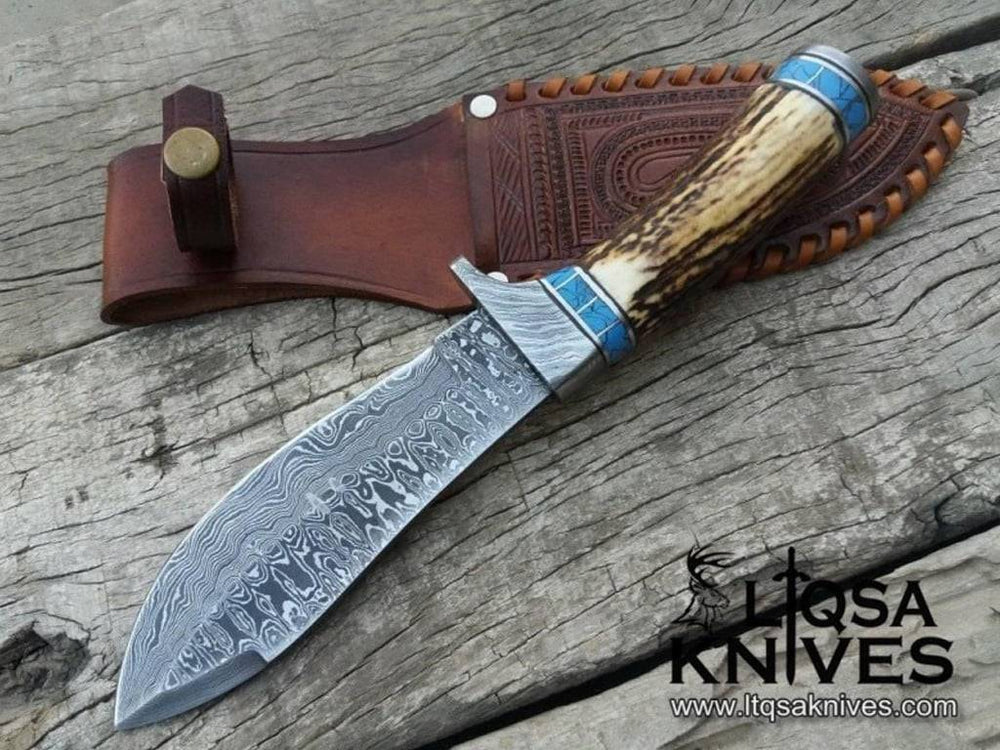 A Real Damascus Knife with a ladder pattern, deer antler handle, and turquoise stone liners.