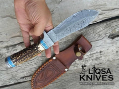 Best Fixed Blade hunting Knife with a drop point blade and a Damascus steel hilt and pommel.