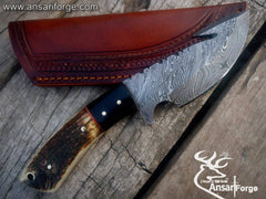 Best Damascus Gut Hook Knife showcasing the 512-layer twist pattern Damascus steel blade and deer/stag antler handle & Leather sheath.