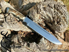 Custom D2 steel Bowie knife with stag antler handle, mirror-polished 11-inch blade, and leather sheath. Handcrafted by Ansari Forge.