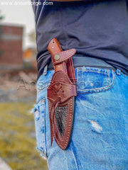 A Camp guy hanging Damascus Camping knife in his belt