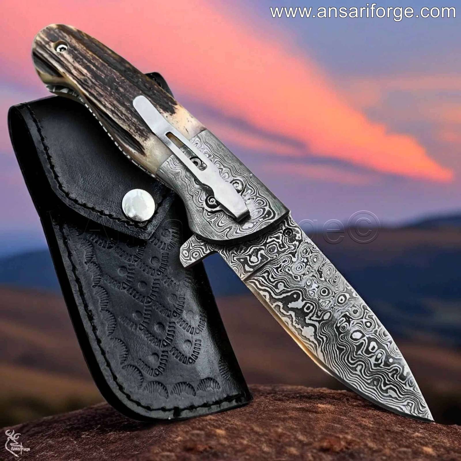 Ansari Forge Damascus pocket knife open, showcasing raindrop pattern blade and Sambar stag antler handle.