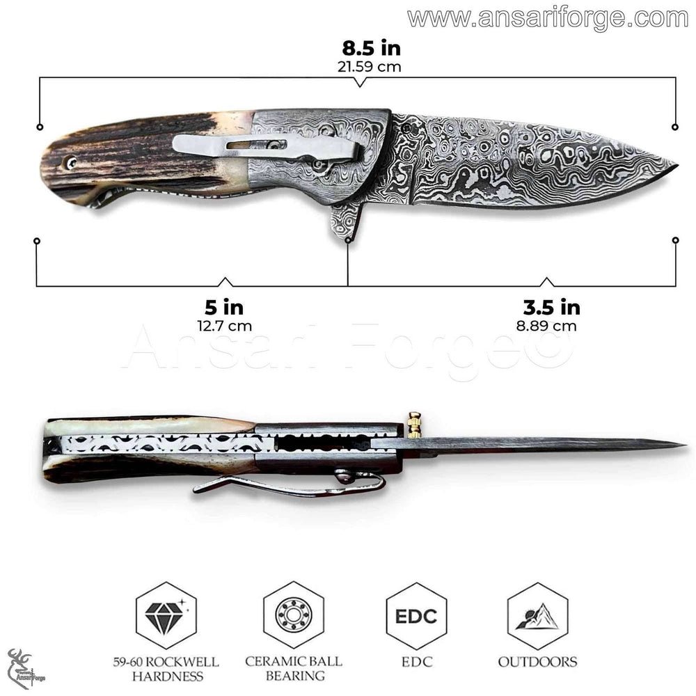 Close-up of hand-forged Damascus folding blade with intricate raindrop pattern and sharp cutting edge.