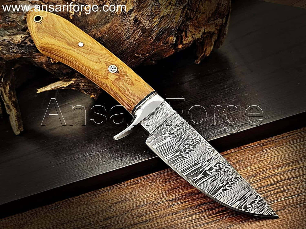 Handmade Damascus steel knife with unique fire pattern, stainless steel finger guard, olive wood handle, and genuine cowhide leather sheath. Overall length 9 inches.