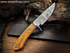 Handcrafted Damascus steel knife with unique fire pattern, stainless steel finger guard, olive wood handle, and genuine cowhide leather sheath.