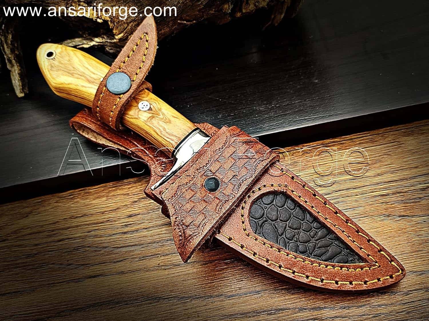 Custom Handmade Damascus steel knife with unique fire pattern, stainless steel finger guard, olive wood handle, and genuine cowhide leather sheath. Overall length 9 inches.