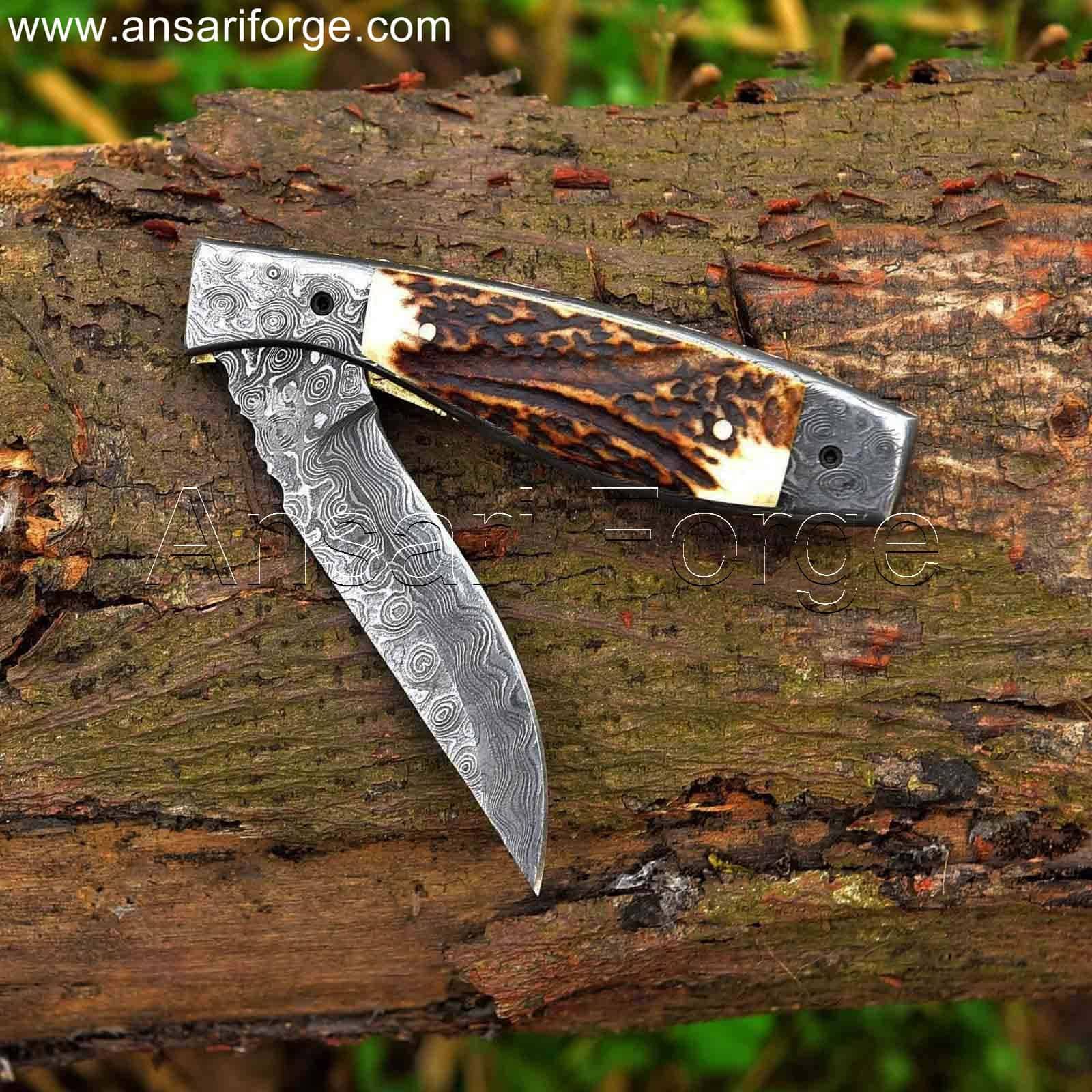 Hand-forged Damascus steel pocket knife with raindrop pattern, stag antler handle, and genuine leather sheath.