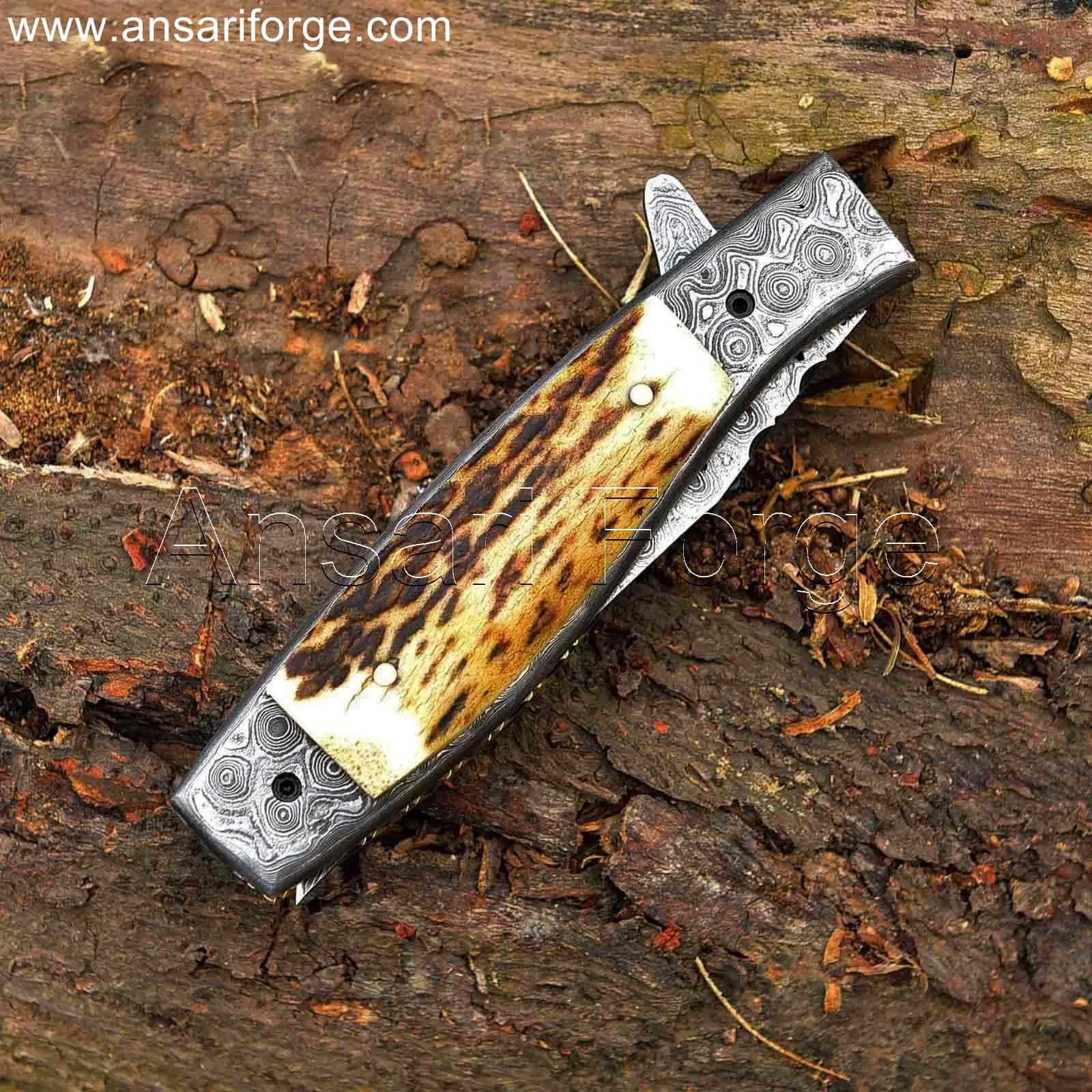 Handmade Damascus steel pocket knife with raindrop pattern, stag antler handle, and genuine leather sheath.