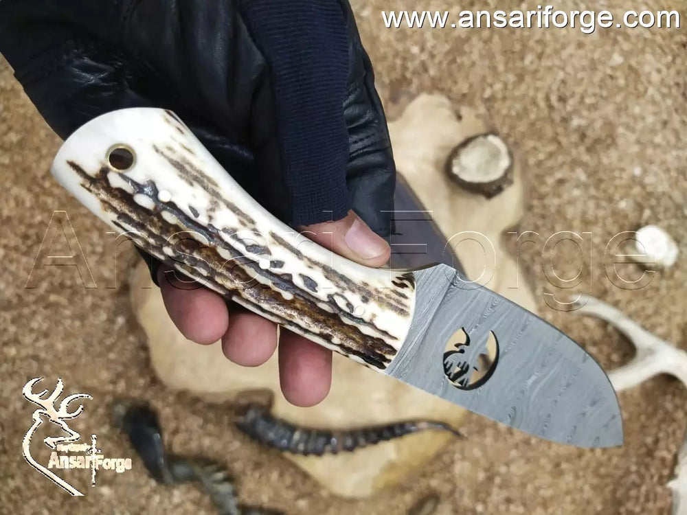 Ergonomic deer antler knife handle showing the secure grip and full tang construction.