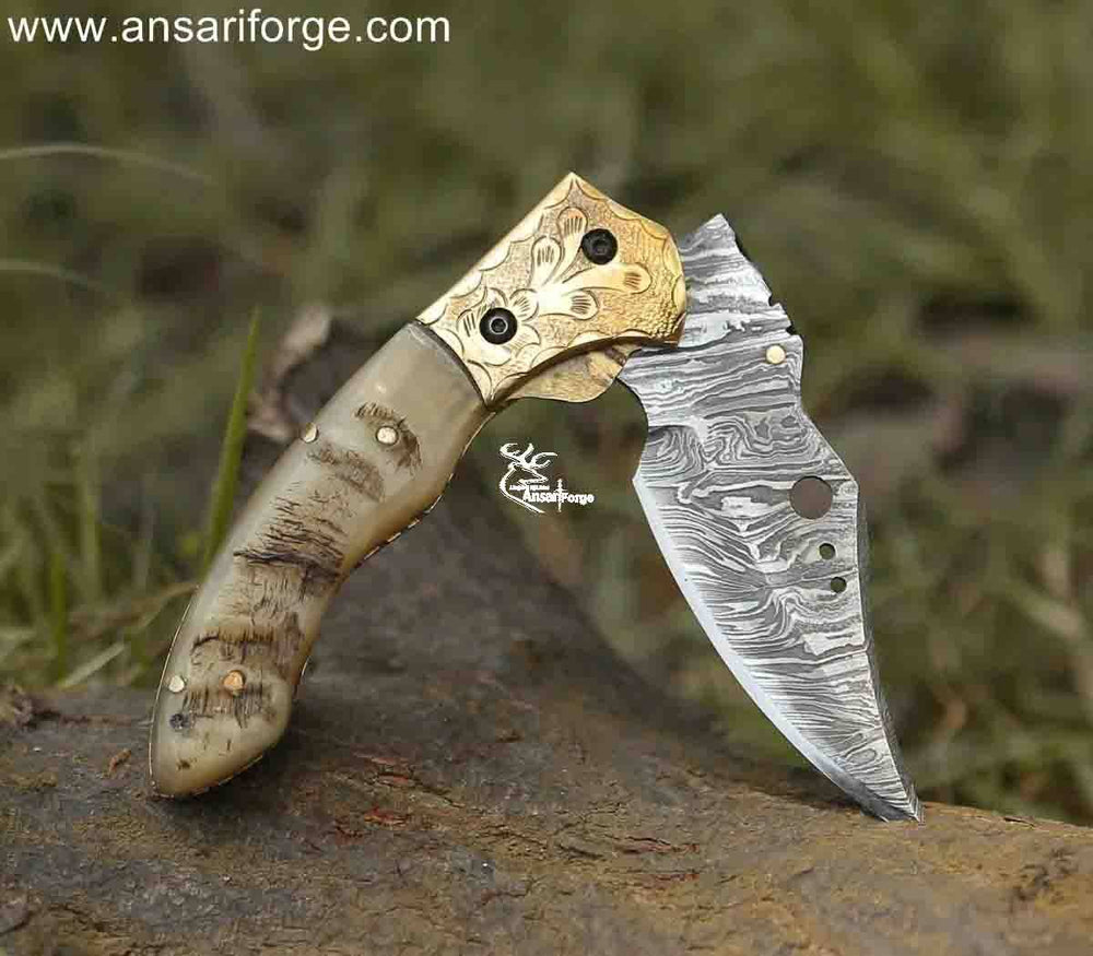 andmade Damascus pocket knife showcasing its smooth liner lock mechanism, engraved bolsters, and unique ram horn handle