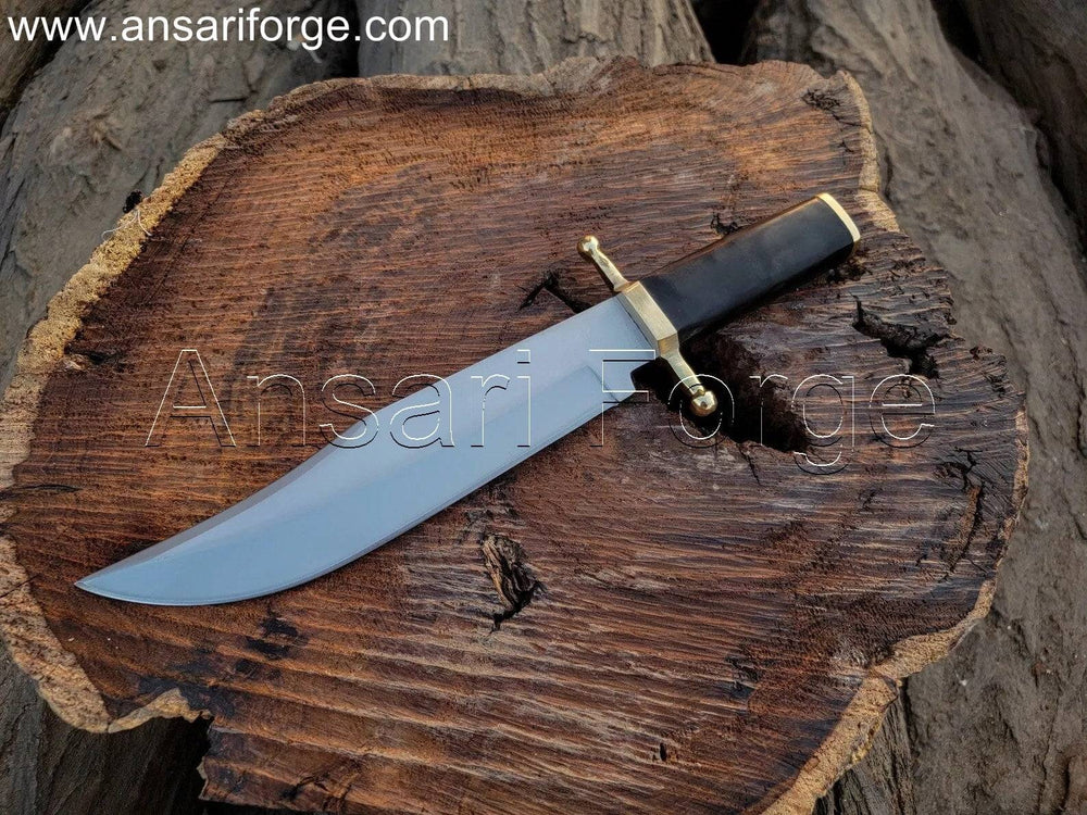Hand-forged Smithsonian Bowie Knife with 5160 steel clip point blade, brass guard, buffalo horn handle, and leather sheath. Overall length 16 inches.