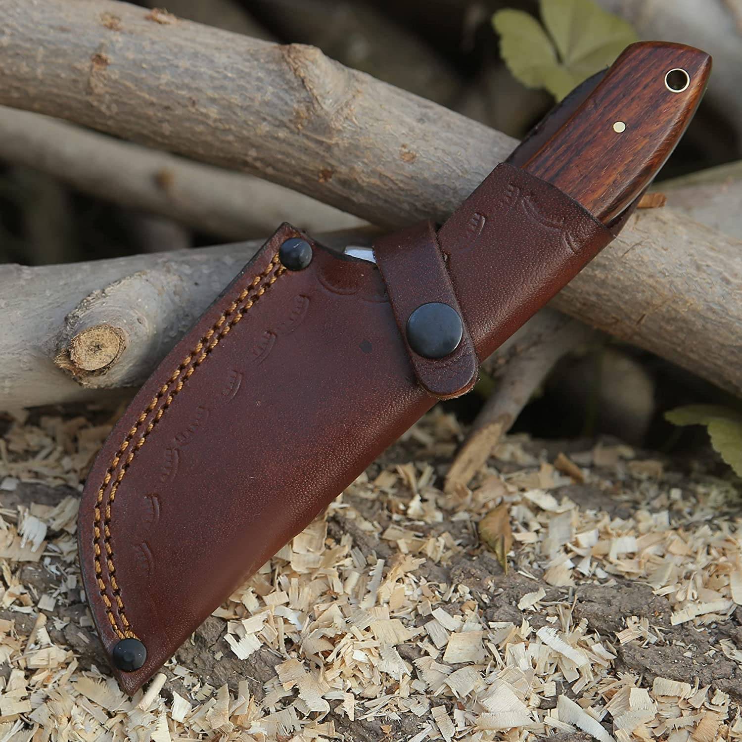 Hunting knife with gut hook displayed in its handmade leather sheath, designed for easy belt carry during outdoor adventures.