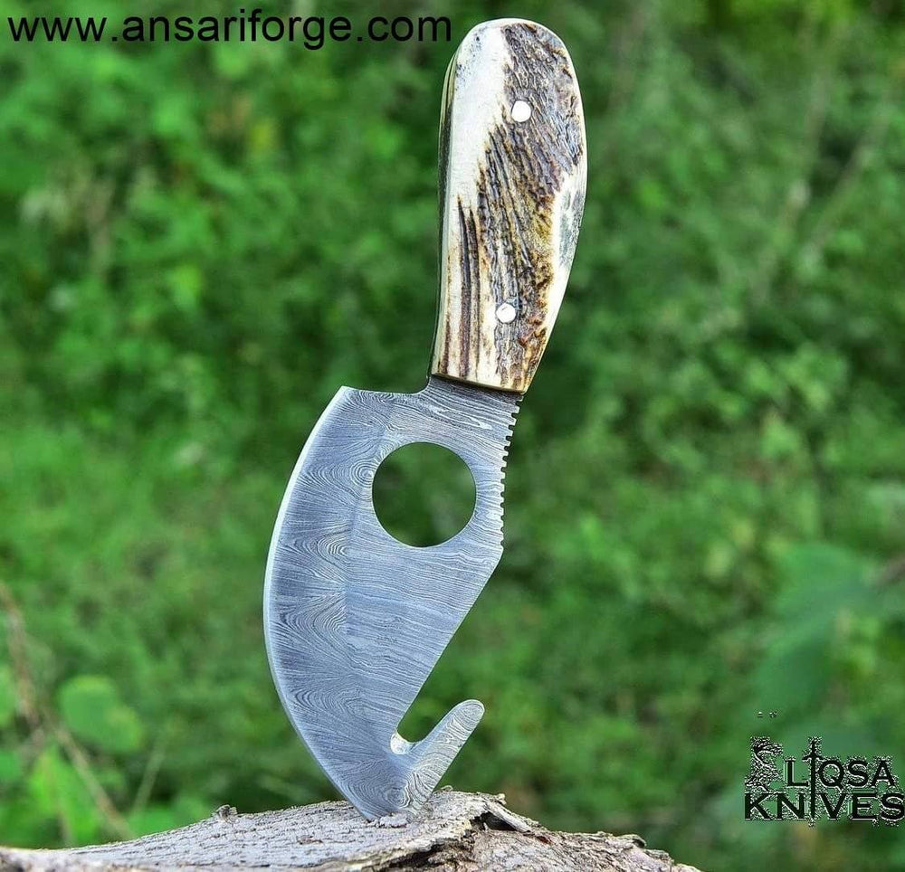 Detailed image of the stag antler handle of the Damascus gut hook knife, highlighting its unique texture and design.