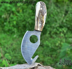 Detailed image of the stag antler handle of the Damascus gut hook knife, highlighting its unique texture and design.