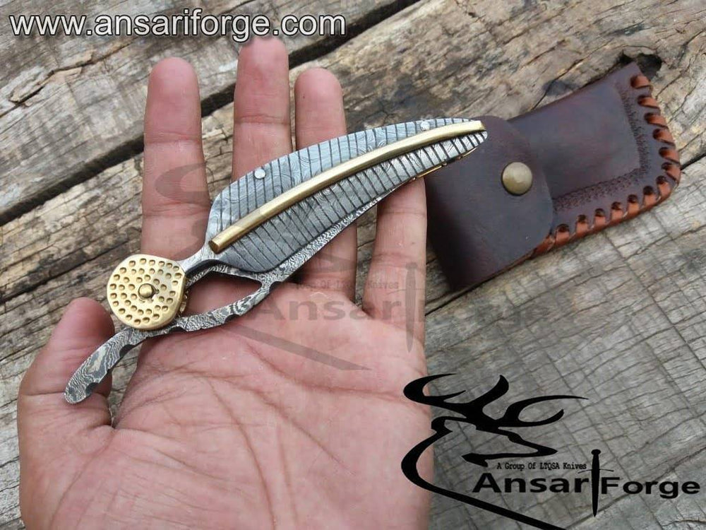 Person holding the Handmade Damascus Pocket Knife, demonstrating its ergonomic handle and comfortable grip.