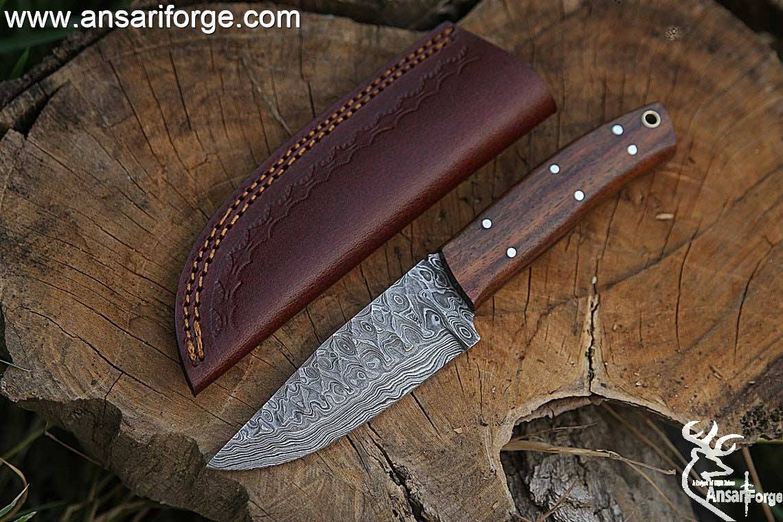 Handmade Damascus steel hunting deer skinning knife with leather sheath .