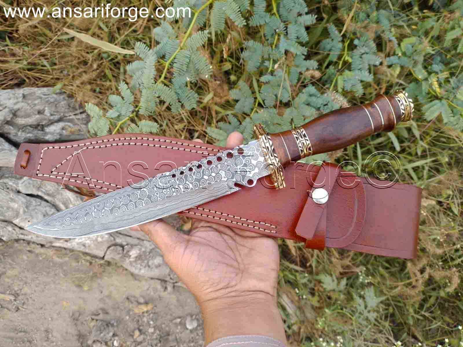 Detailed view of the 7-inch Damascus steel blade of the hunting knife with sheath, showcasing the intricate raindrop pattern.