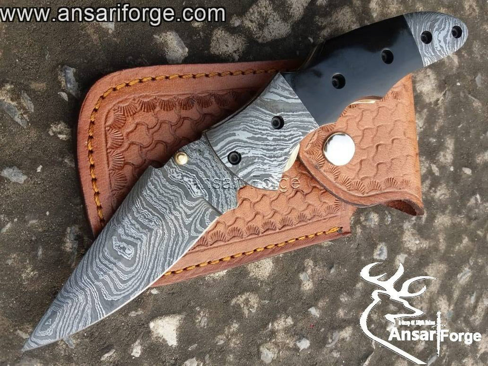 Damascus folding knife by Ansari Forge.