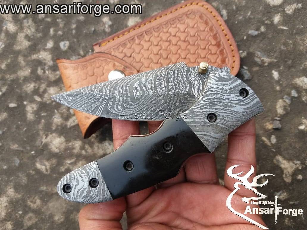 EDC Damascus pocket knife with stainless steel pocket clip.