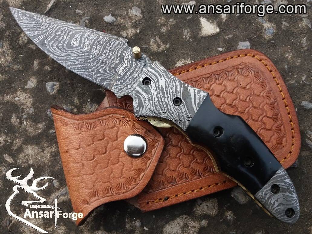 Handmade Damascus pocket knife with buffalo horn handle.