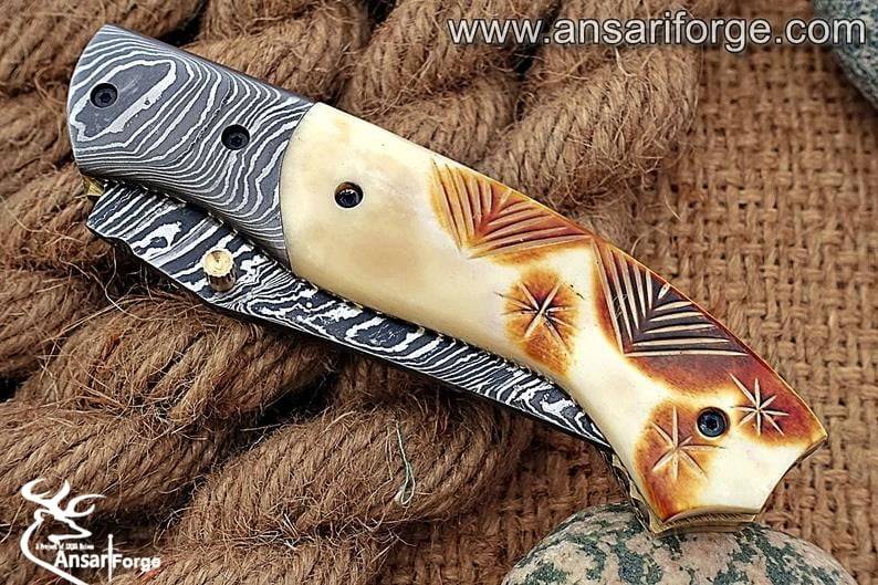 Close-up of the smooth and comfortable camel bone handle on the Damascus Pocket Knife.