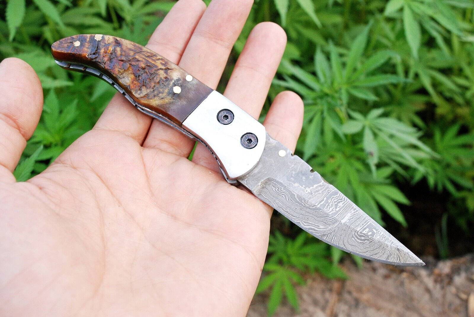 Close-up of twist pattern Damascus folding blade.