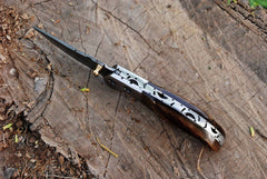 Drop point blade with stainless steel bolsters and file work.