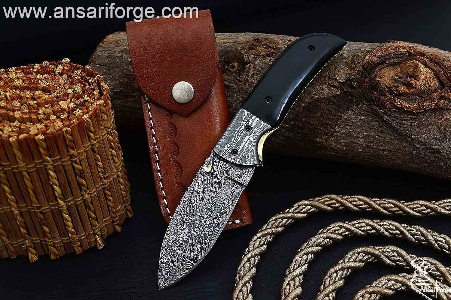Damascus pocket knife with black micarta handle and brass spine file work.