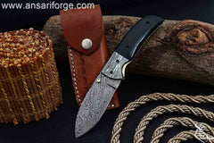 Damascus pocket knife with black micarta handle and brass spine file work.