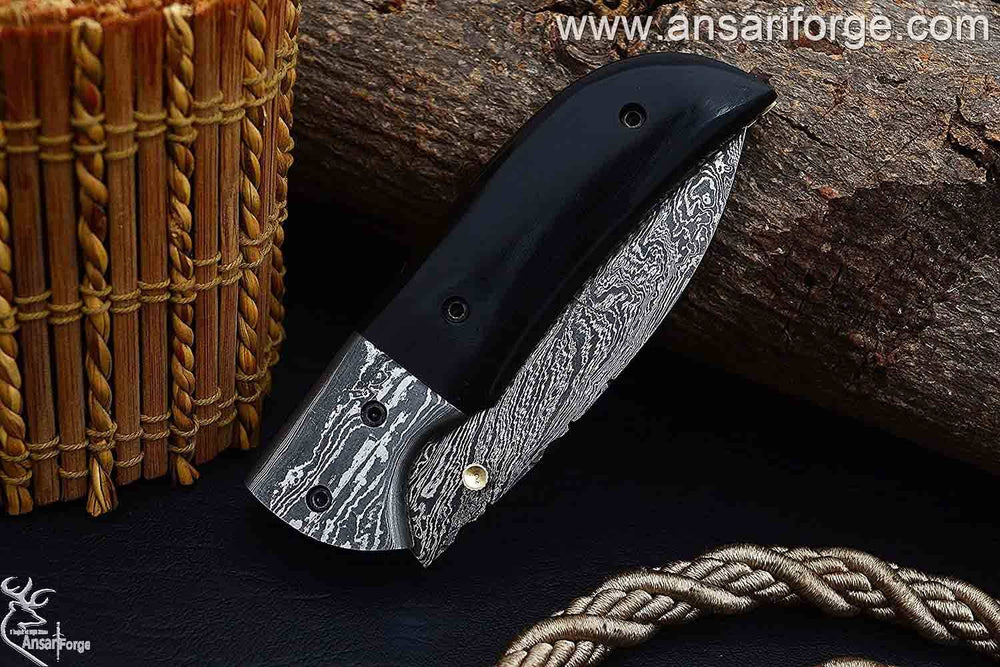 Closed Damascus pocket knife with brass frame and micarta handle.